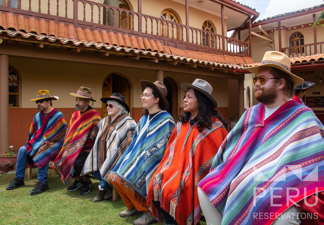 https://www.peru-reservations.com/wp-content/uploads/2025/10/grupo_de_turistas_con_ponchos_y_sombreros-group_of_tourists_with_ponchos_and_hats.png