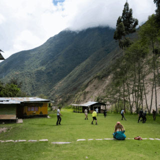 https://www.peru-reservations.com/wp-content/uploads/2025/11/grupo_de_personas_jugando_futbol_en_campo_montanoso-group_of_people_playing_soccer_in_mountainous_field-320x320.png