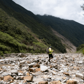 senderista_en_valle_montañoso_rocoso_con_río-hiker_in_rocky_mountain_valley_with_river